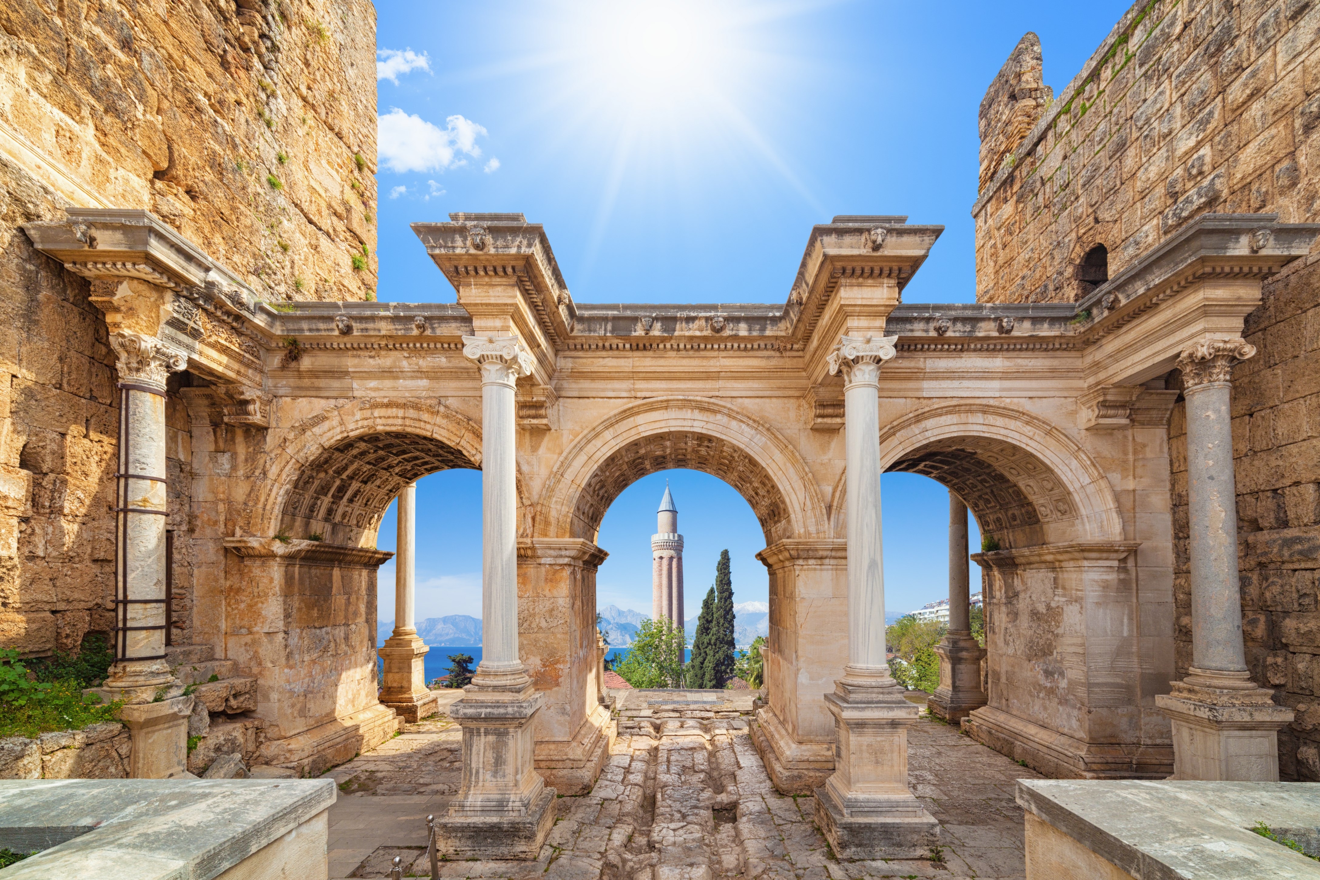 Welcome to amazing Antalya concept. Collage of famous landmarks: Hadrian's Gate old town Kaleici district and Yivli Minare Mosque or Alaaddin Mosque in popular resort city Antalya, Turkey