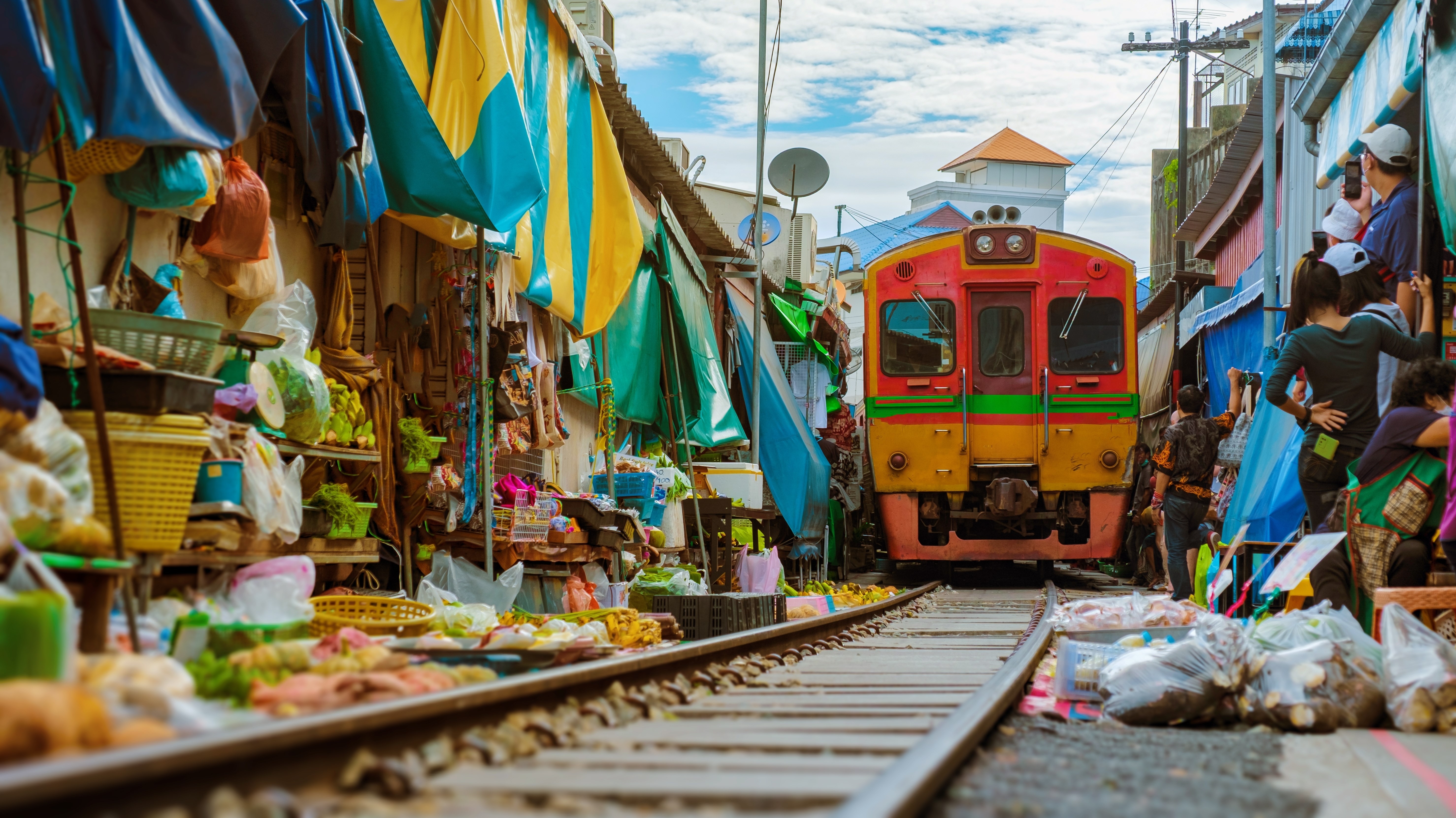 Maeklong Railway Market Thailand, Train on Tracks Moving Slow. Umbrella Fresh Market on the Railroad Track, Mae Klong Train Station, Bangkok, a famous railway market in Thailand