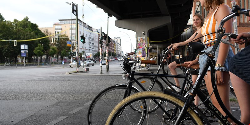 3 women biking around Kreuzberg in the summer, Berlin, Germany