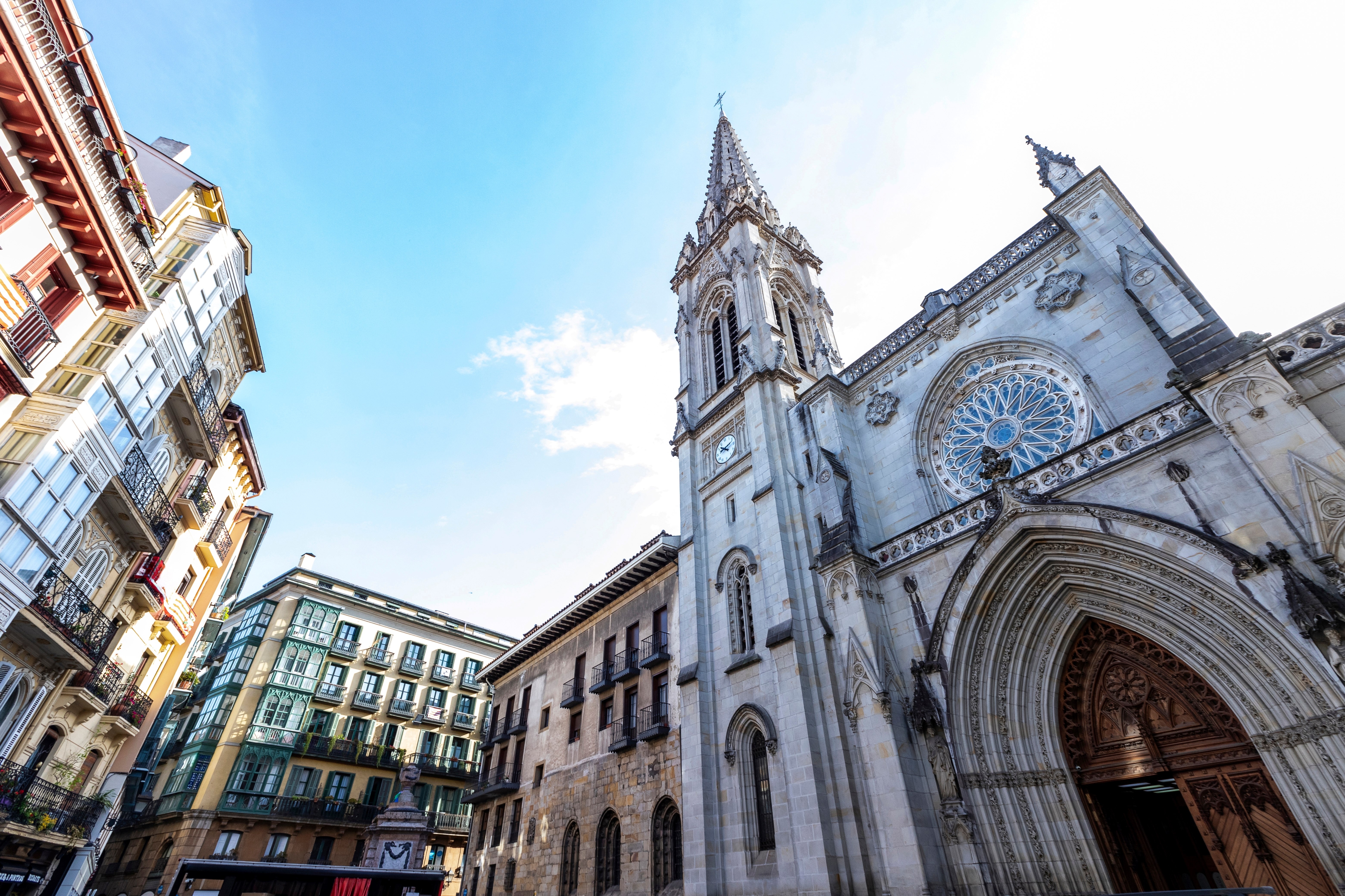 Low angle view of Santiago Cathedral in front of residential buildings in the center of the old city. Bilbao, Basque Country, Spain