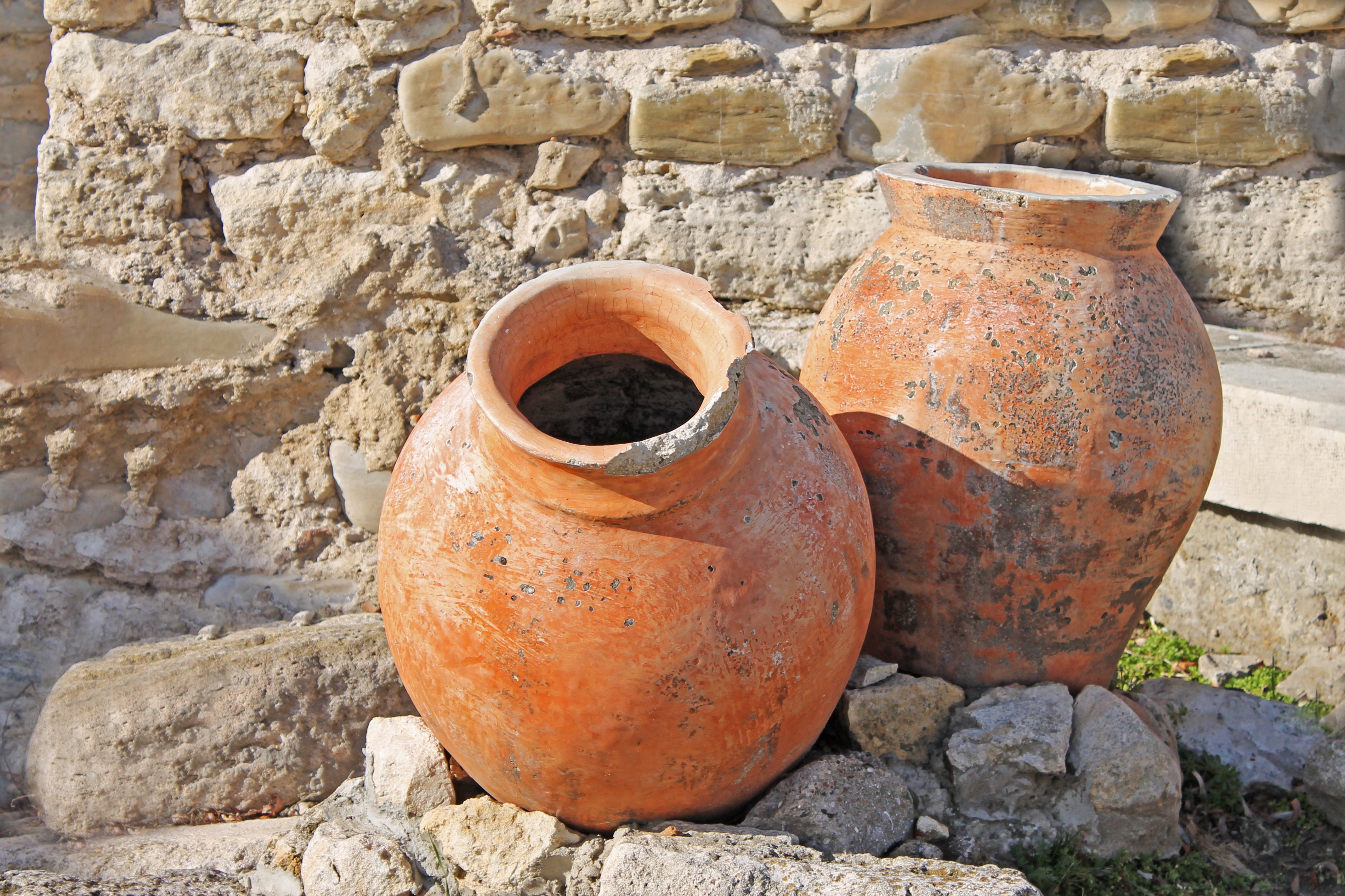 Two antique amphoras on the background of the ruins