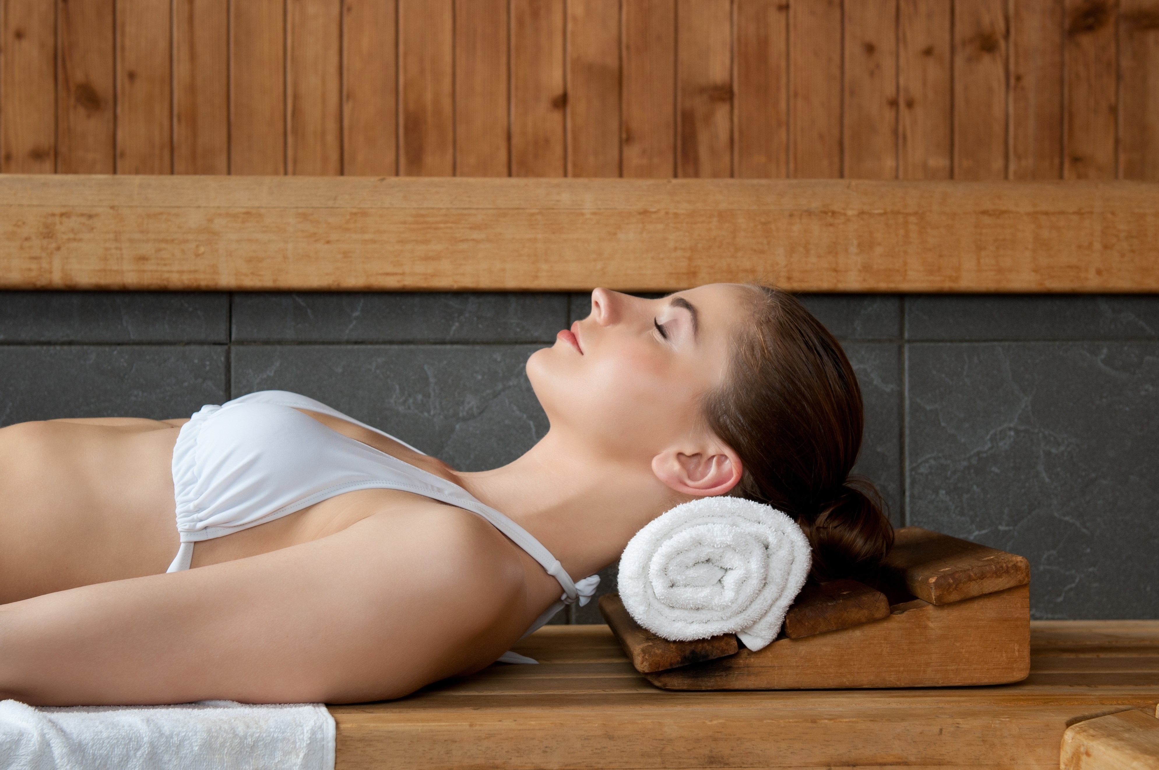 Closeup of beautiful lady relaxing at sauna in a spa center