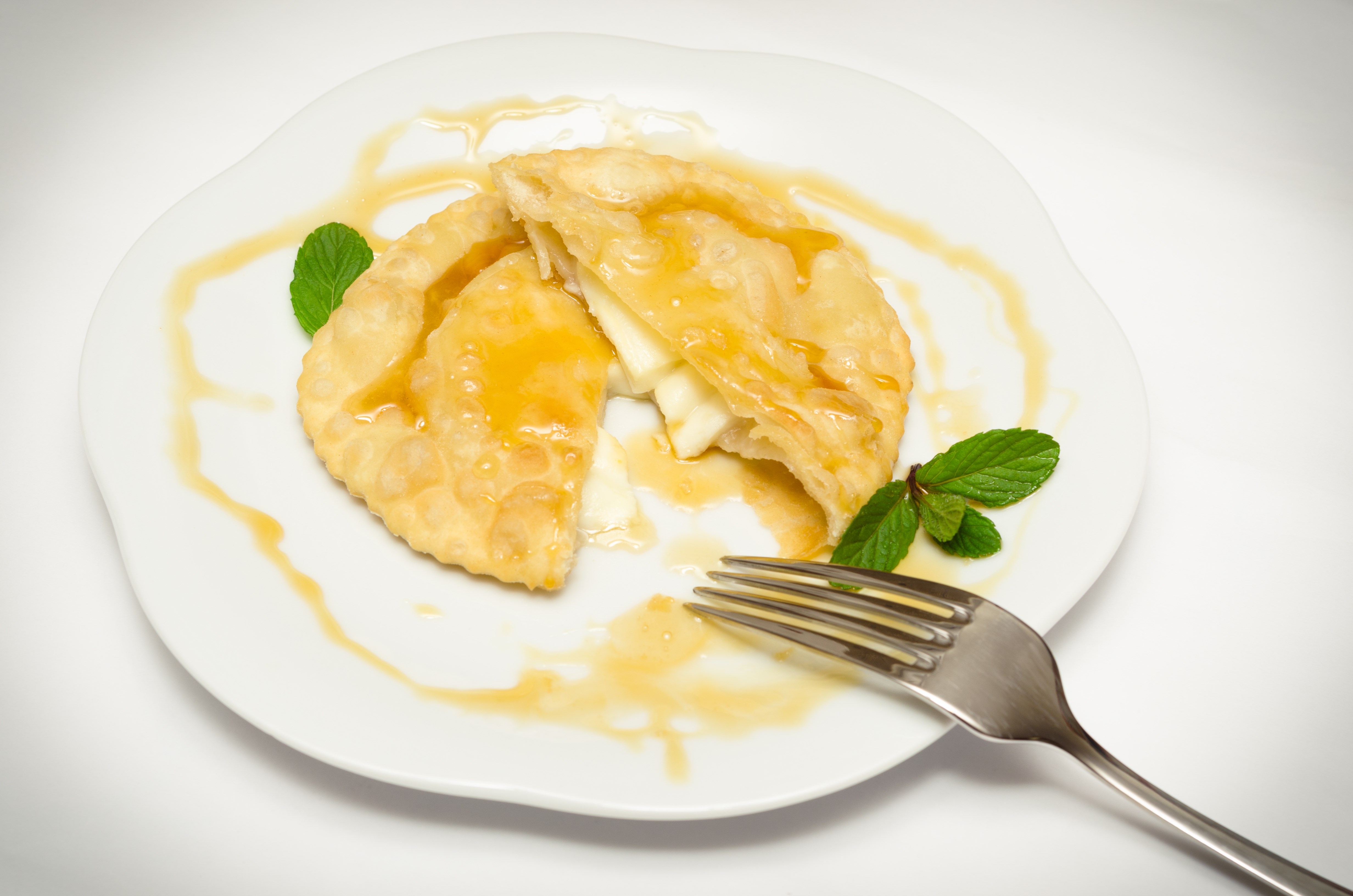 Sebada, traditional dessert made in Sardegna, stuffed with cheese and topped with honey