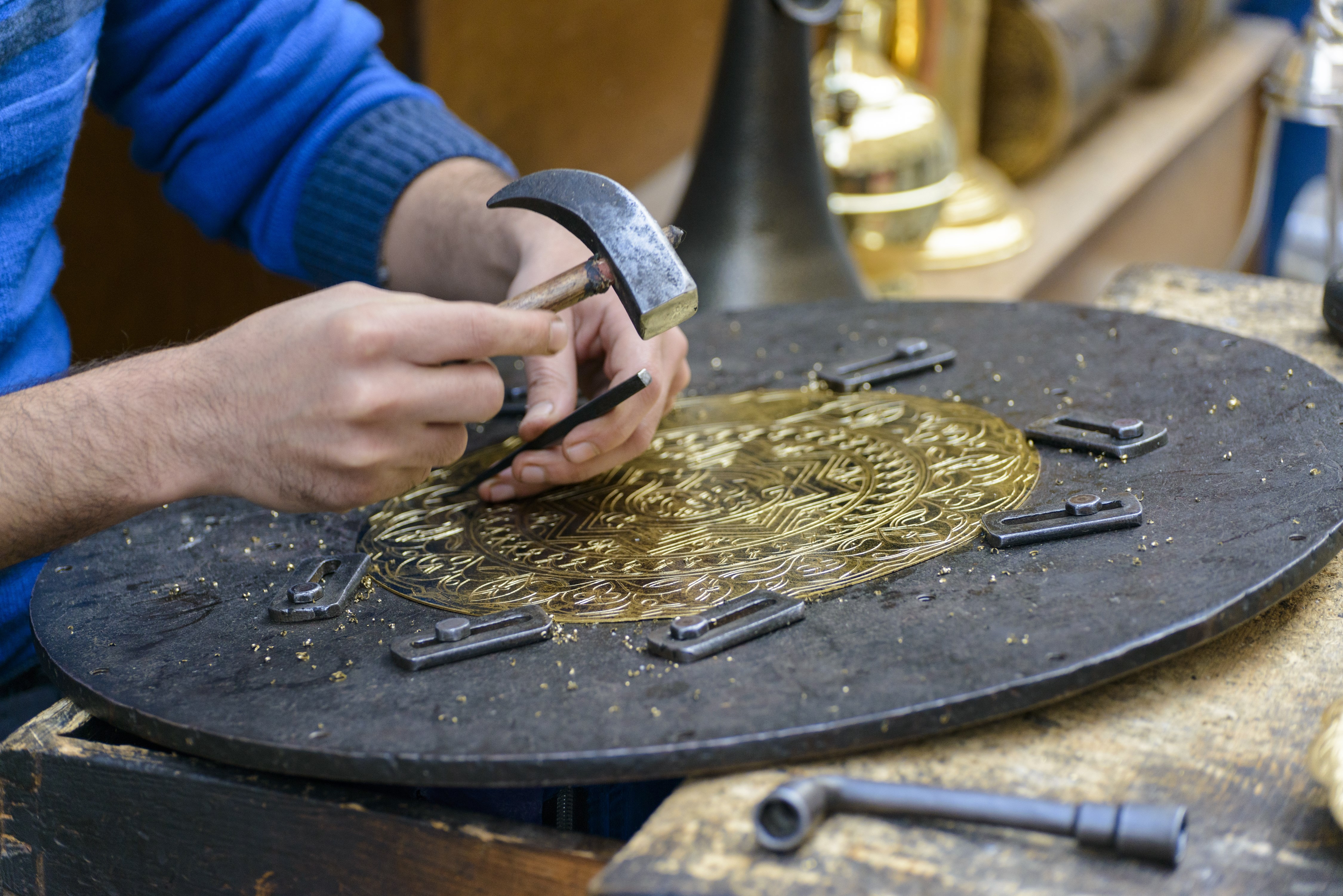 Two Hands of Artist Engraving Brass Plate