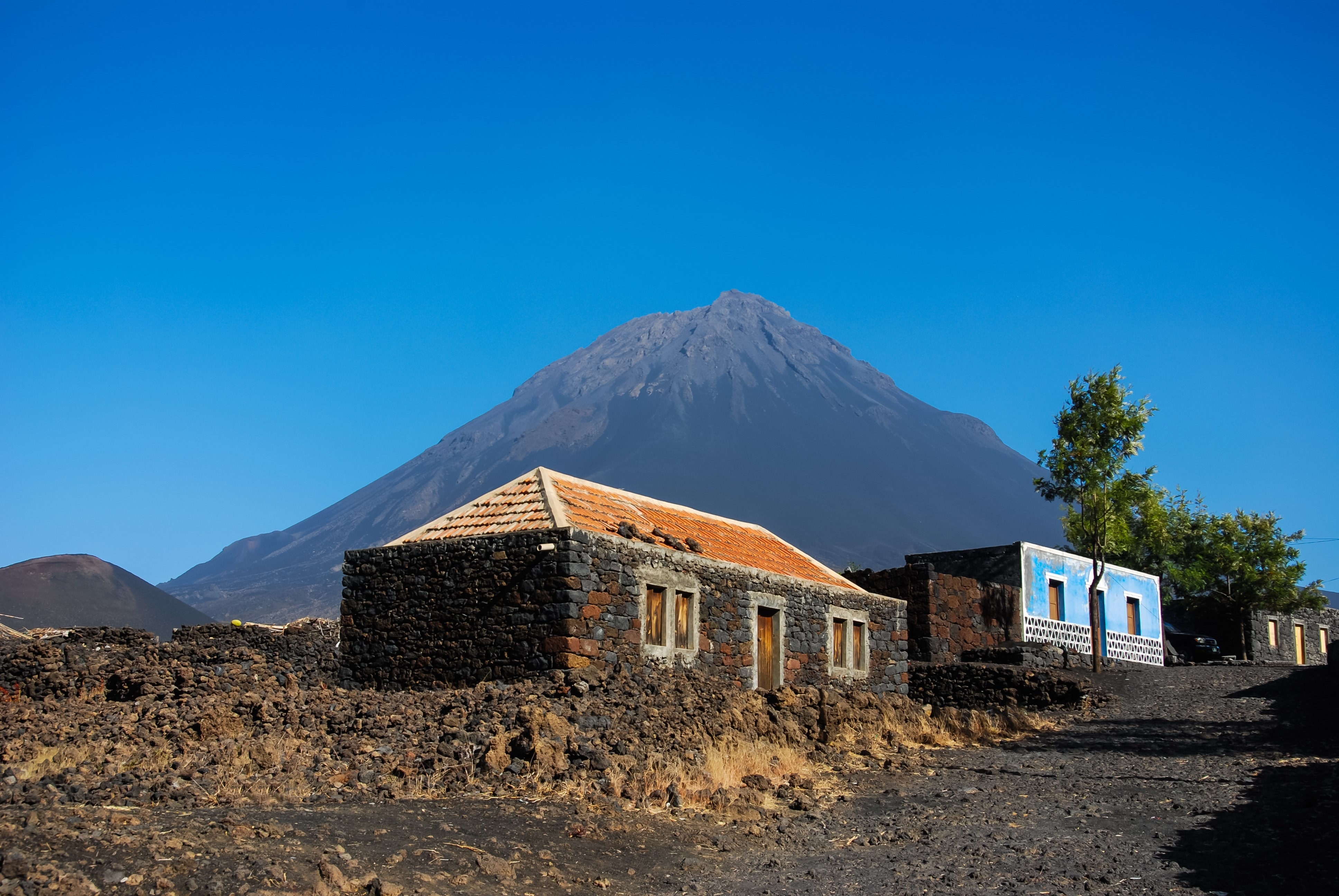 Cabo Verde, Pico do Fogo, Caldera. Volcano Pico do Fogo, 2829 m, the highest mountain of Cabo Verde standing isolated in the burned Lava fields. Hauses of igneous rocks in the Cha das Caldeiras.