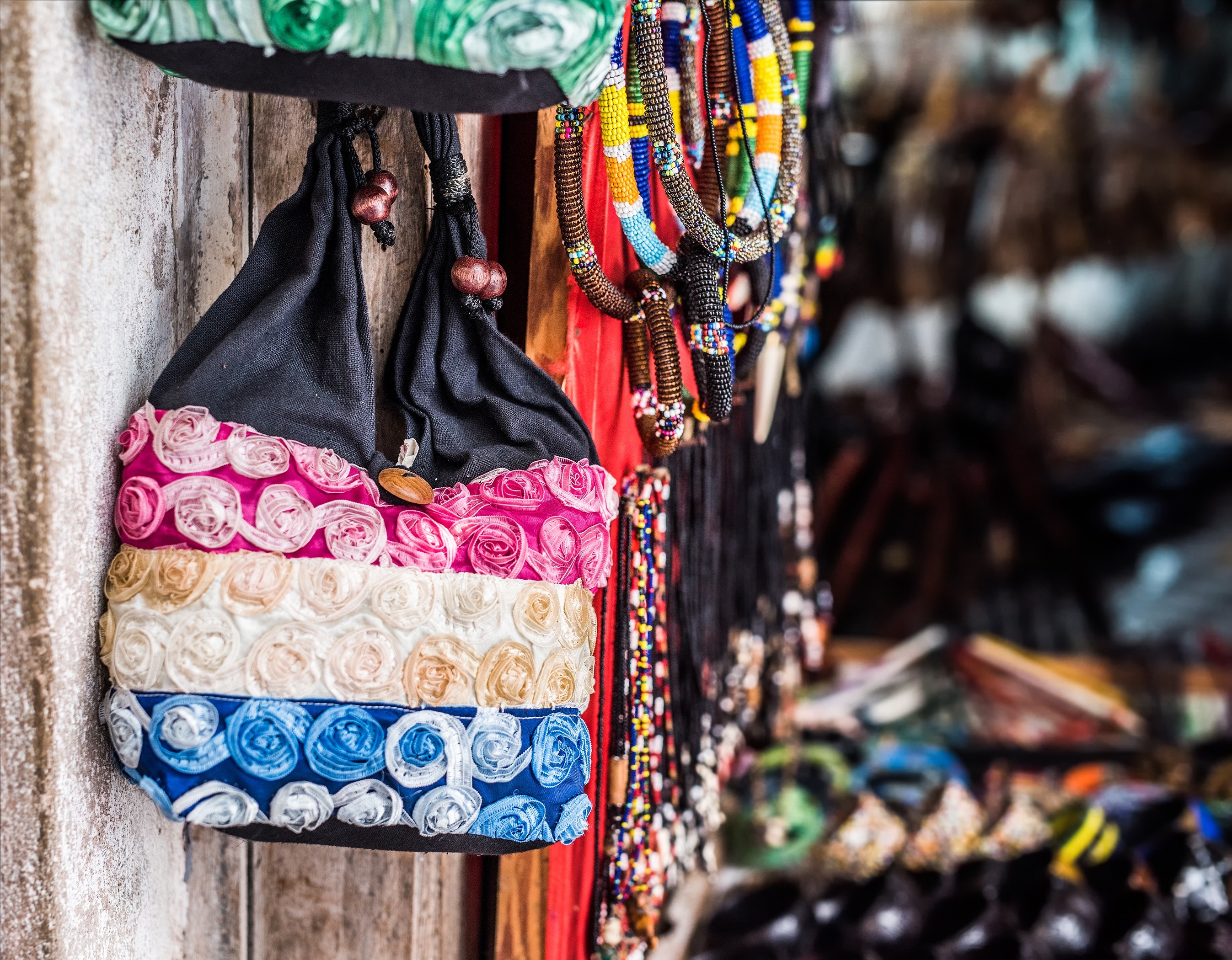 handmade fabric bag hung on a wall for sale in african market street