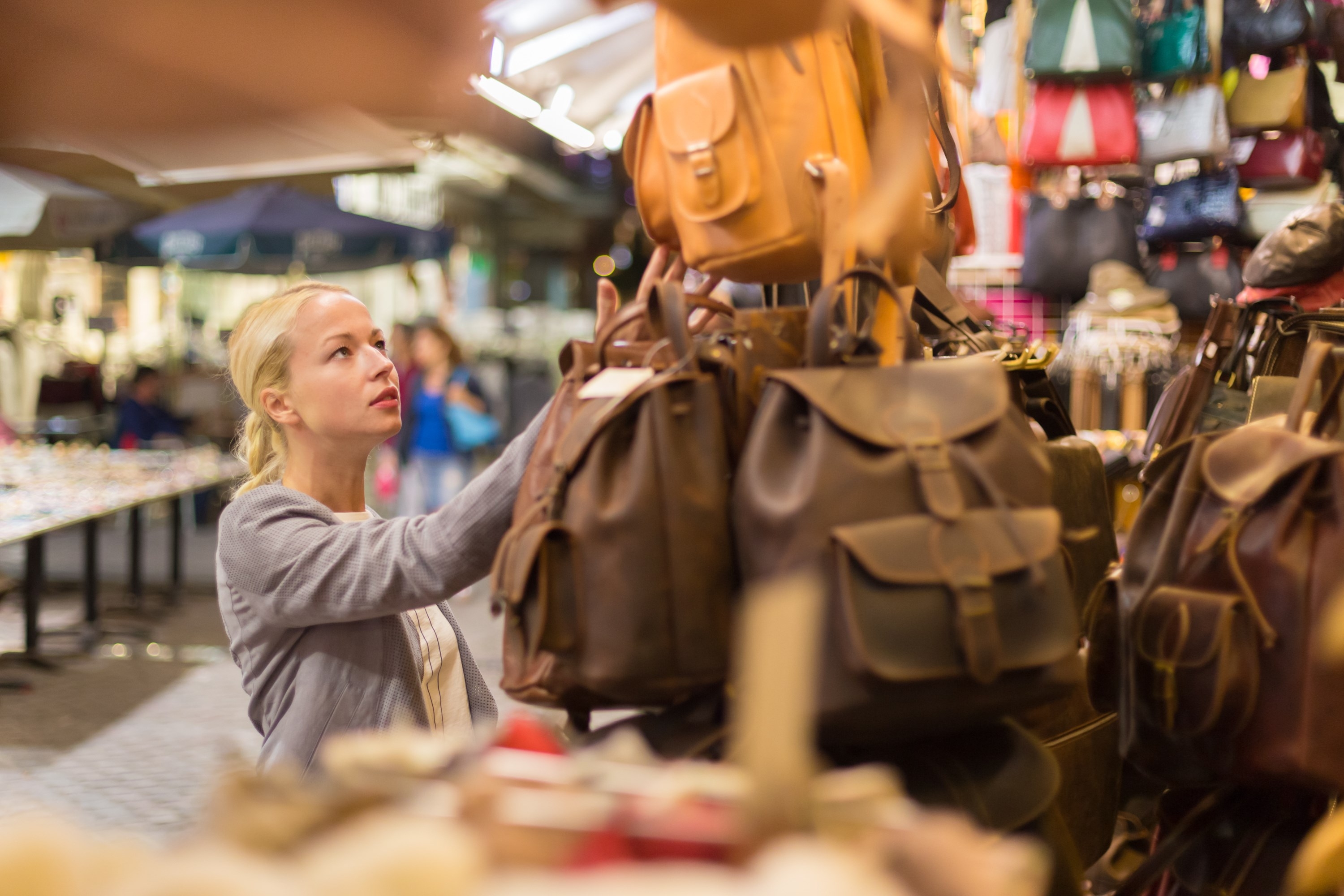 Woman looking at leather bags Chania