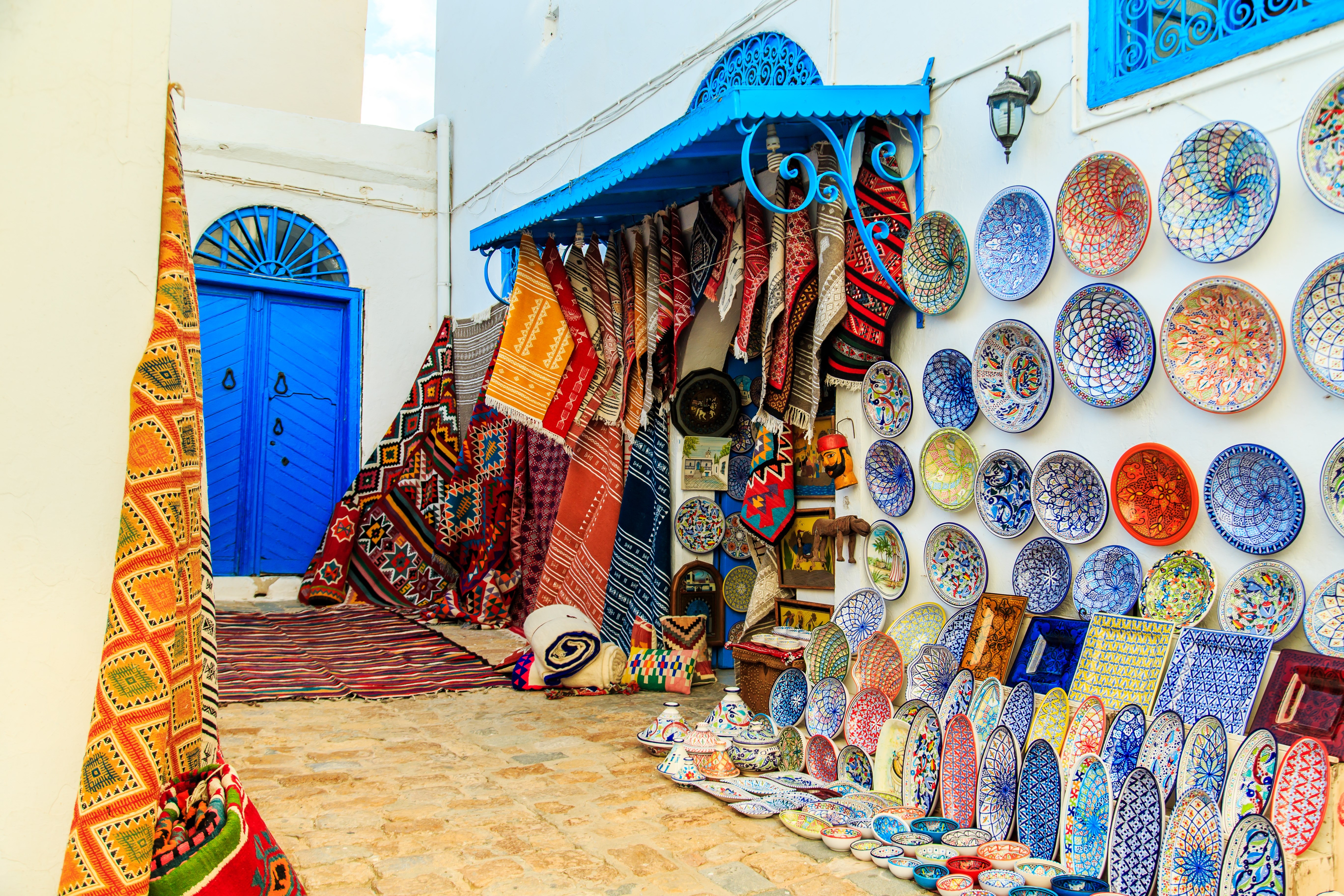 Souvenir earthenware and carpets in tunisian market, Sidi Bou Said, Tunisia. - Image