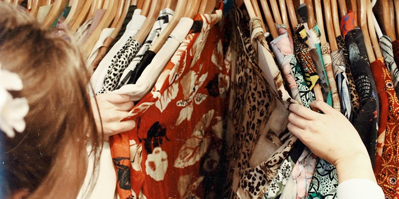woman browsing clothes on hangers