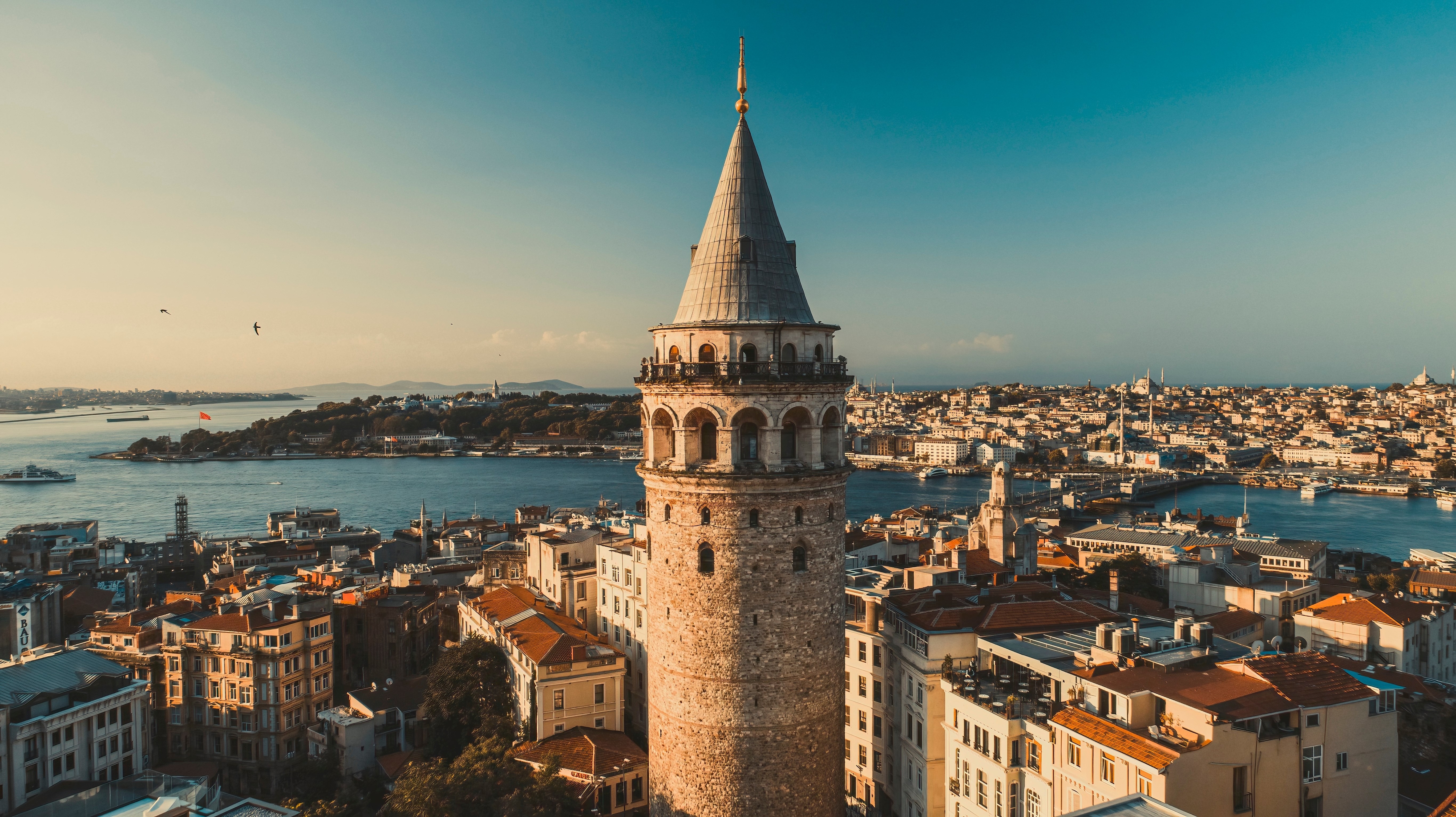 Galata tower. Close-up photo of Galata Tower, one of the few beauties of Istanbul, taken with a drone at sunrise. Magnificent view of the sea and buildings in the background.