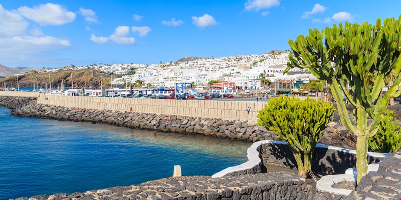 Promenade along ocean coast in Puerto del Carmen holiday town, Lanzarote, Canary Islands, Spain