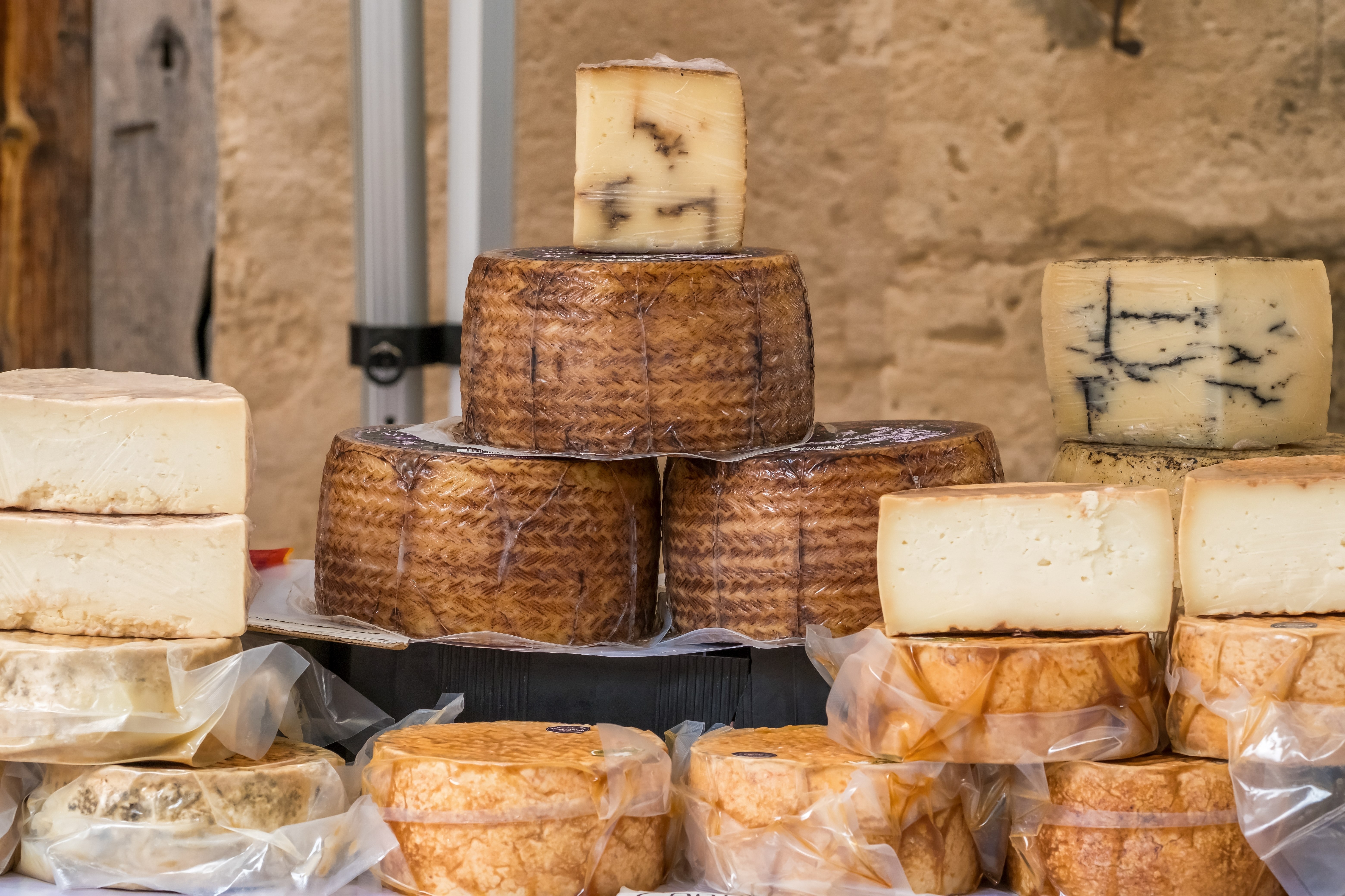 Food stall with local cheeses at a Mallorca farmers’ market in Spain.