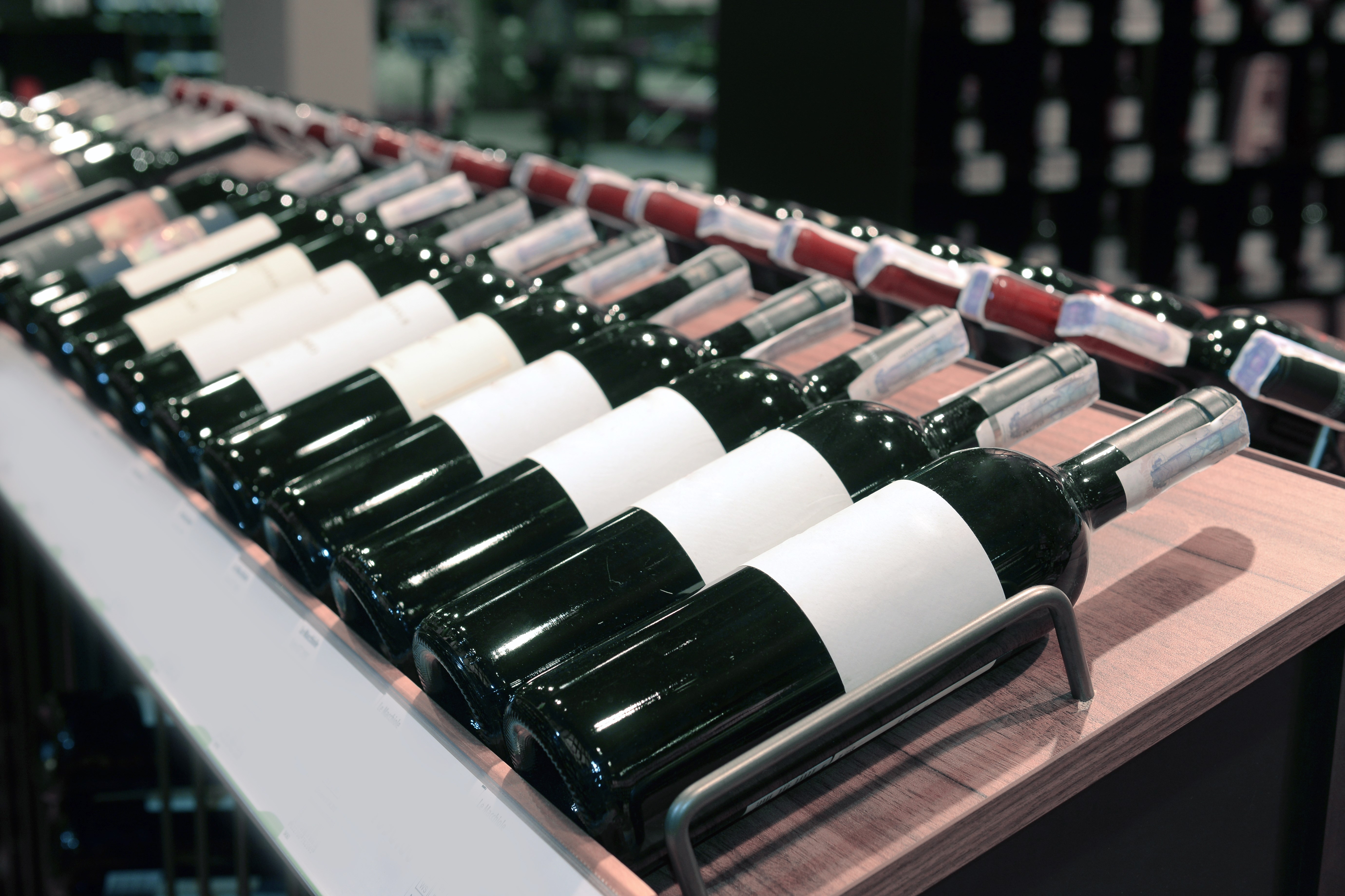 Red and white wine in bottles in wine shop