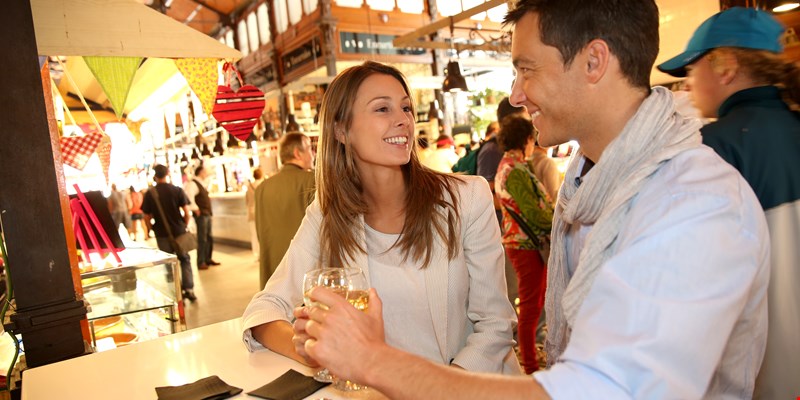 Couple eating tapas in a food market in Madrid, Spain