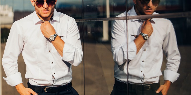 portrait of sexy handsome man in elegant clothes