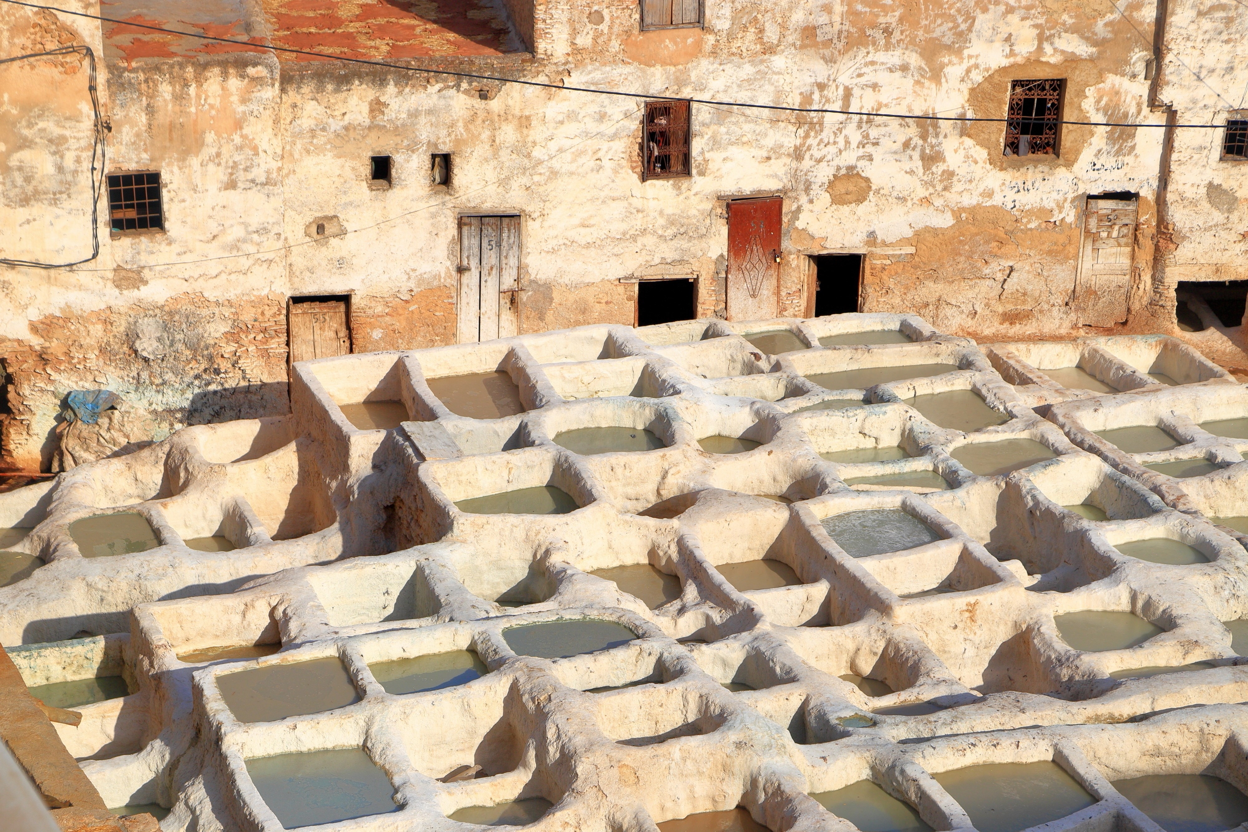 Tannery basins and medieval buildings in the Medina of Fes, Morocco