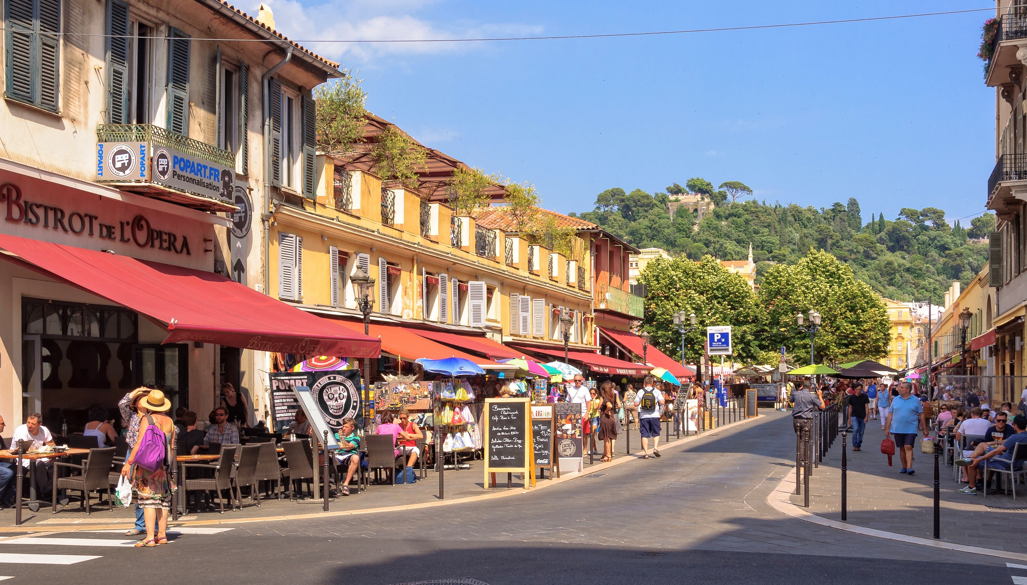 Tourists and locals enjoy a nice meal and drink at the intersection of the Saint-François de Paule and Raoul Bosio streets