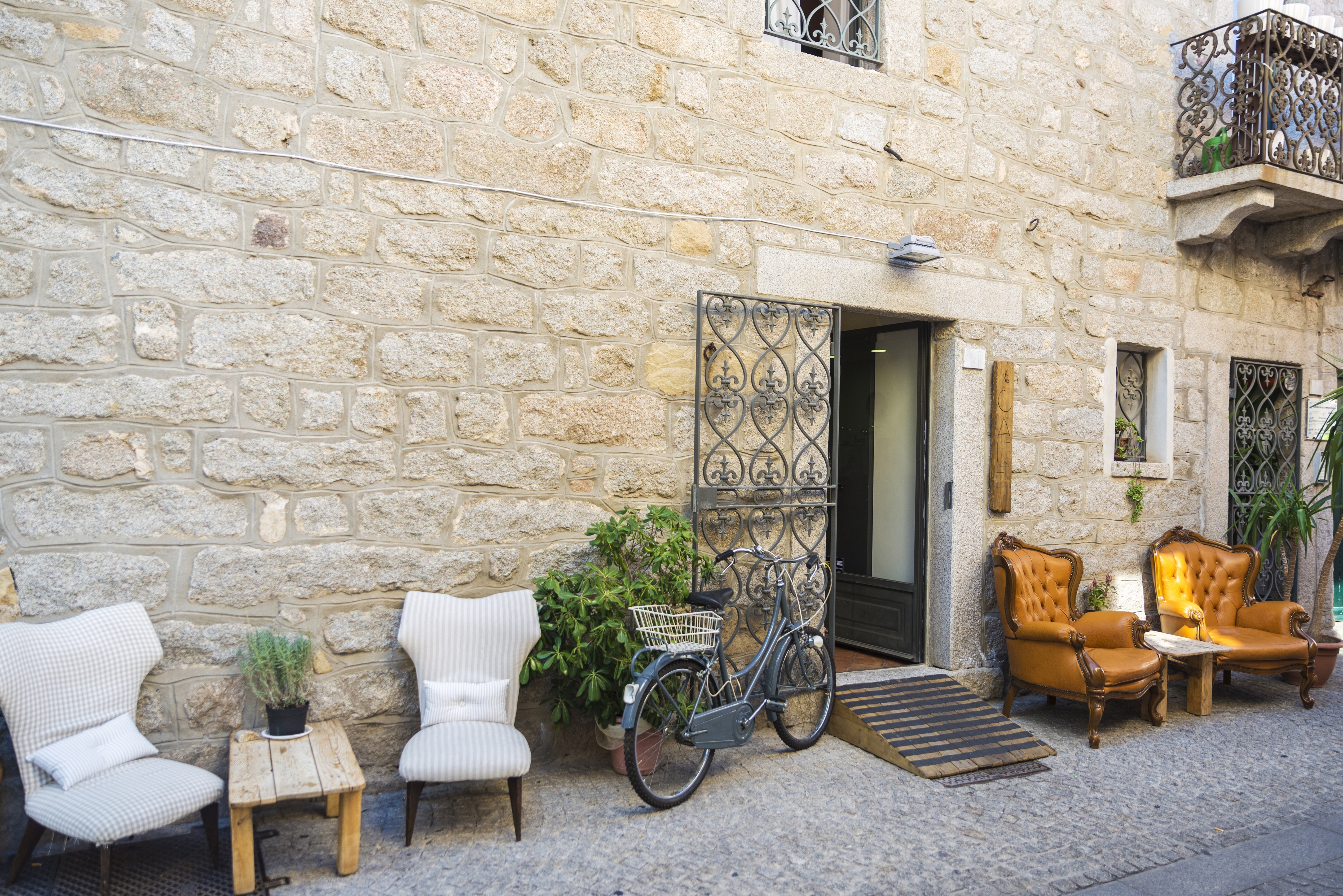 Street of the old town of Olbia with bar terraces in Sardinia, Italy