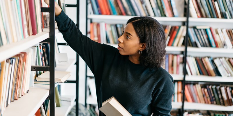 Girl taking books from a shelf