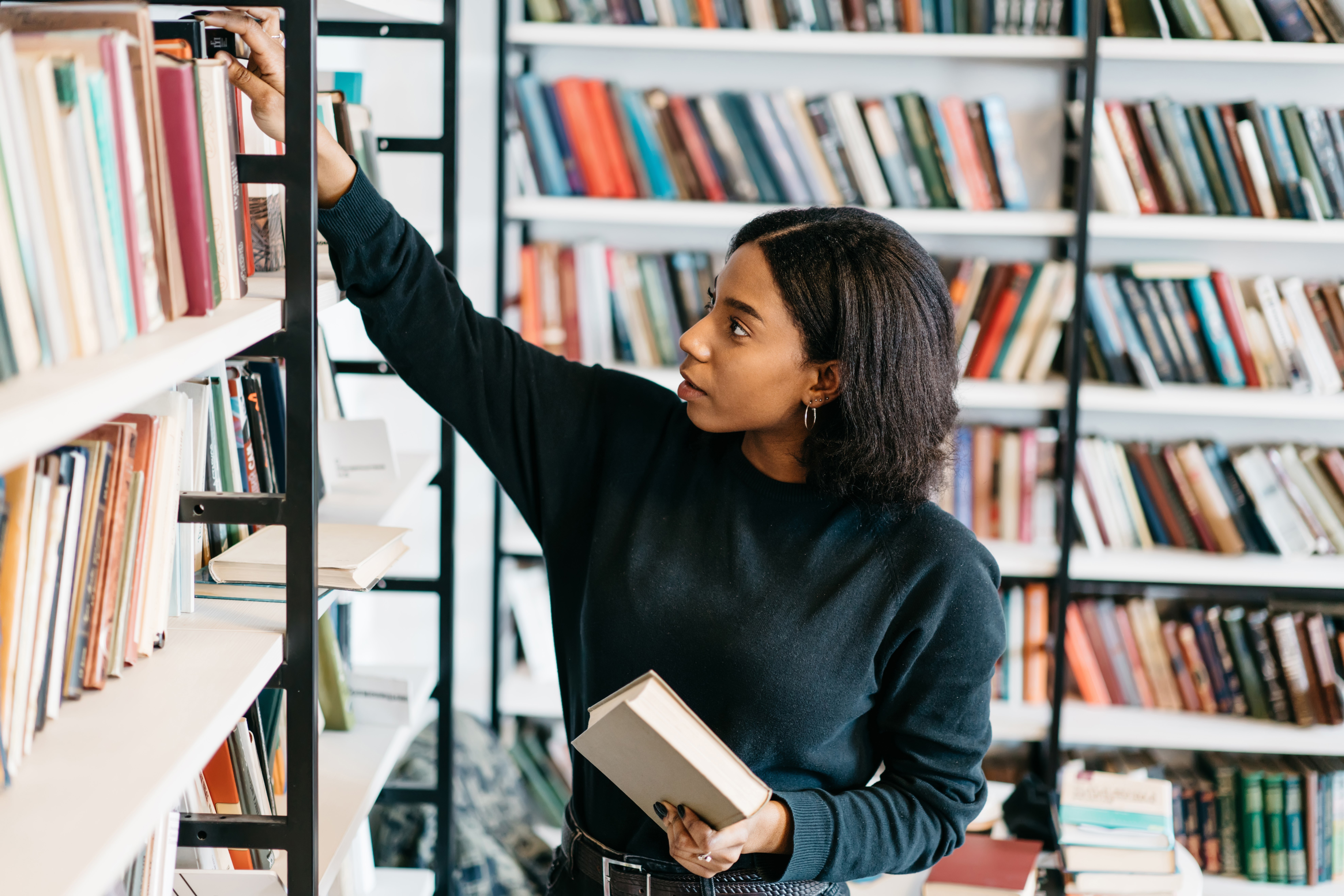 Girl taking books from a shelf