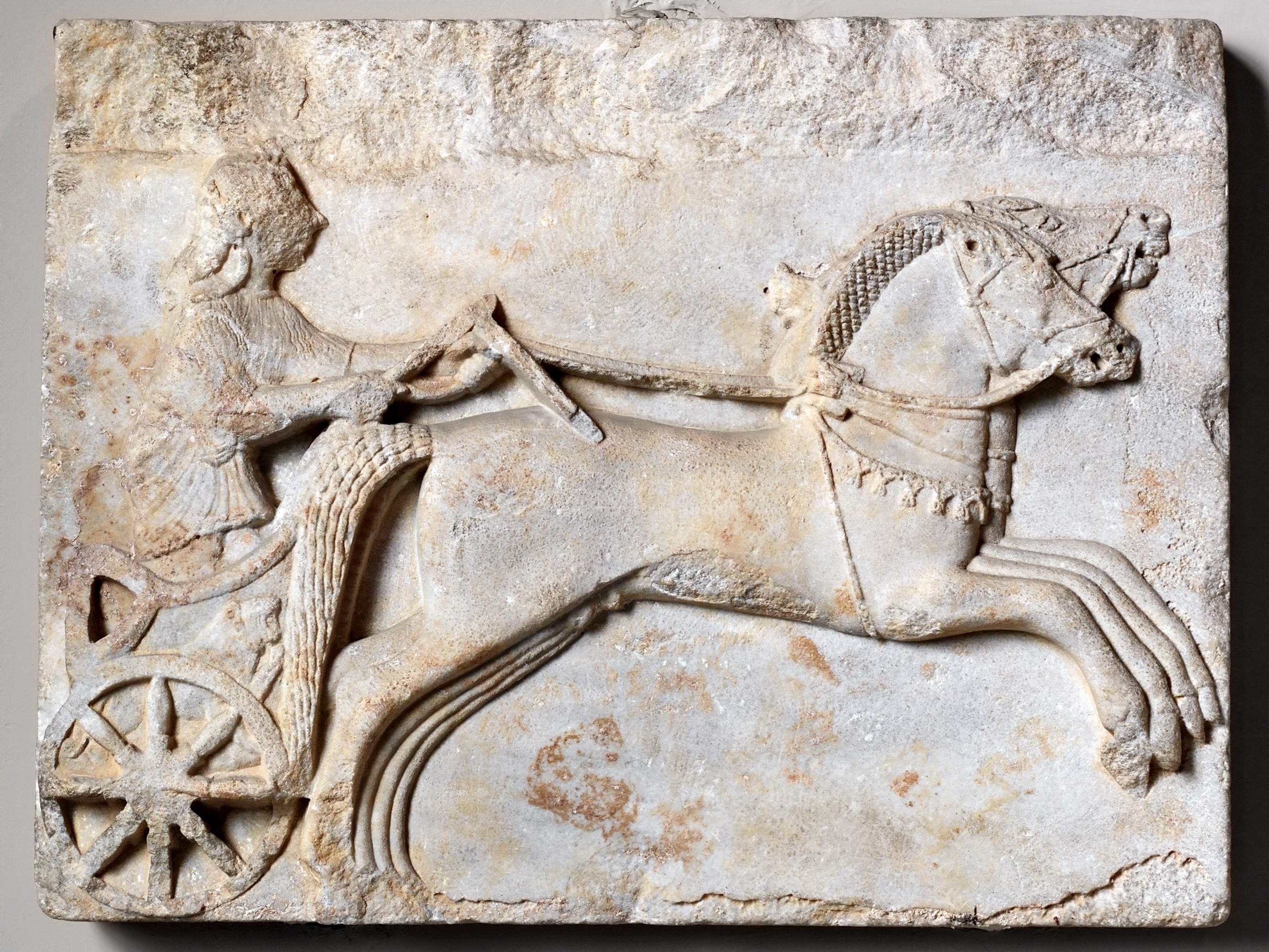 Charioteer driving two horses. Archaic period, 6th century BC.