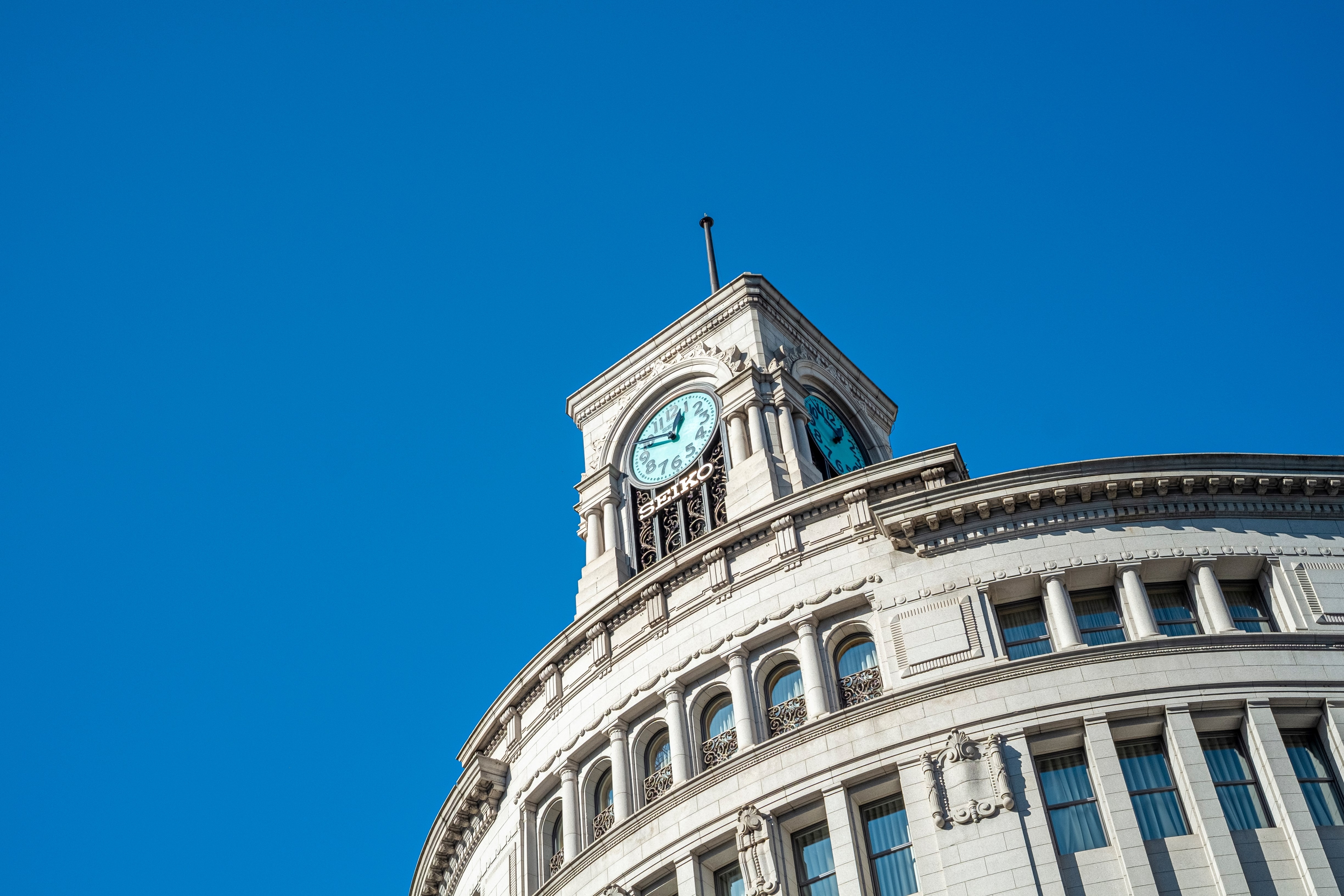 A clock tower in Ginza, Tokyo. The blue sky matches the color of the clock tower and it is beautiful.