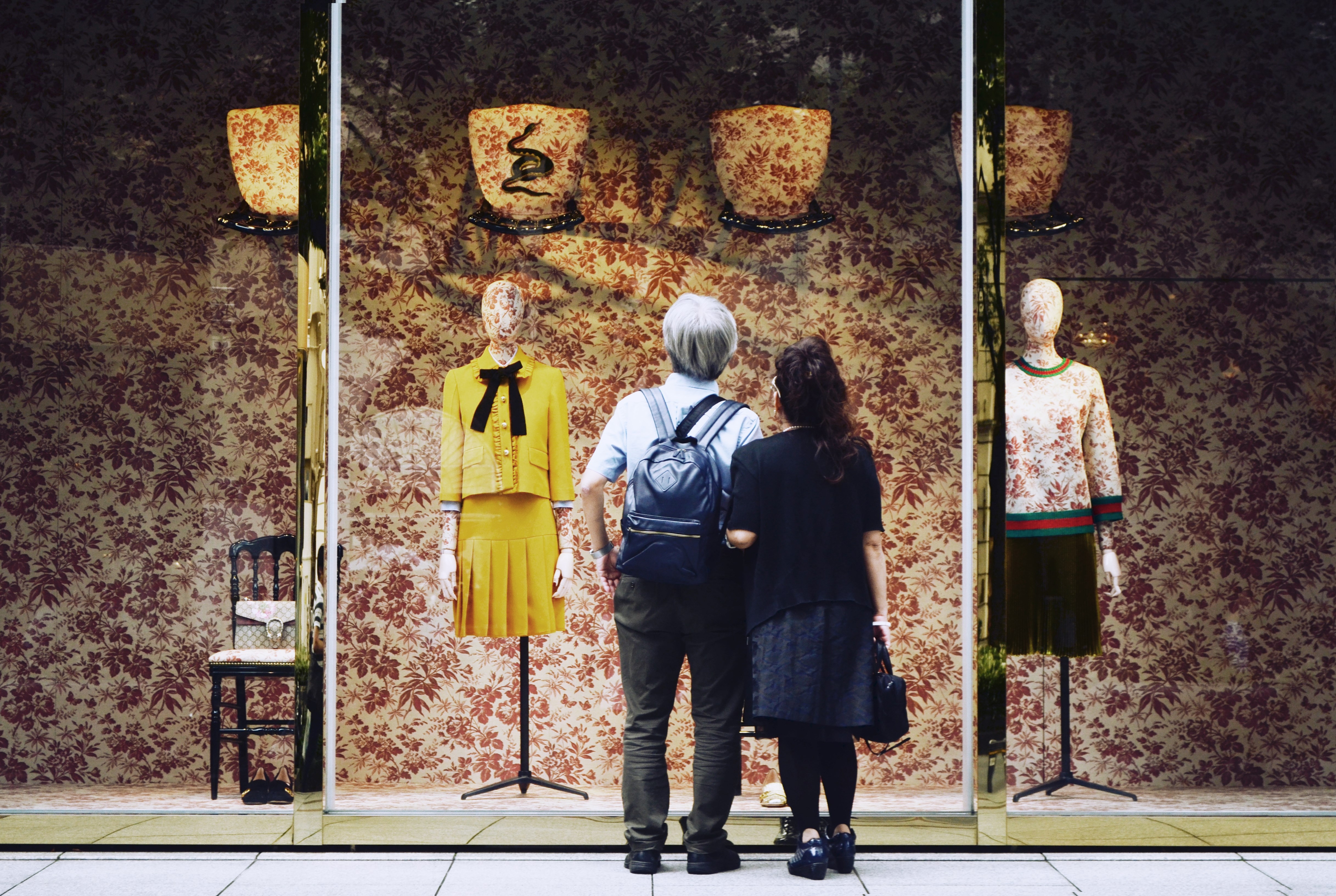 shoppers looking at a window display