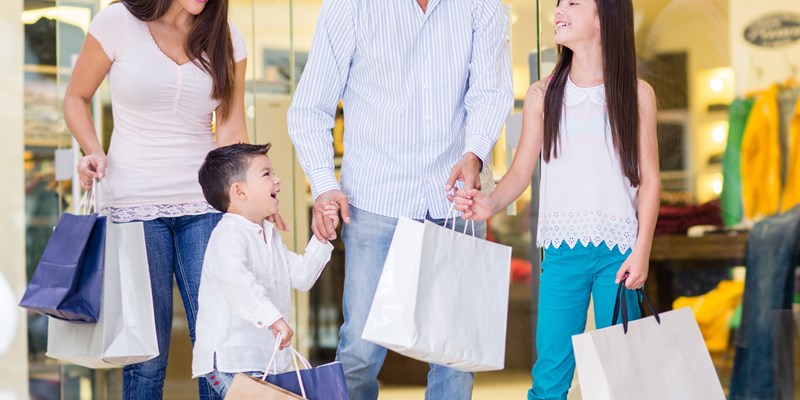 Family shopping at the mall and looking very happy