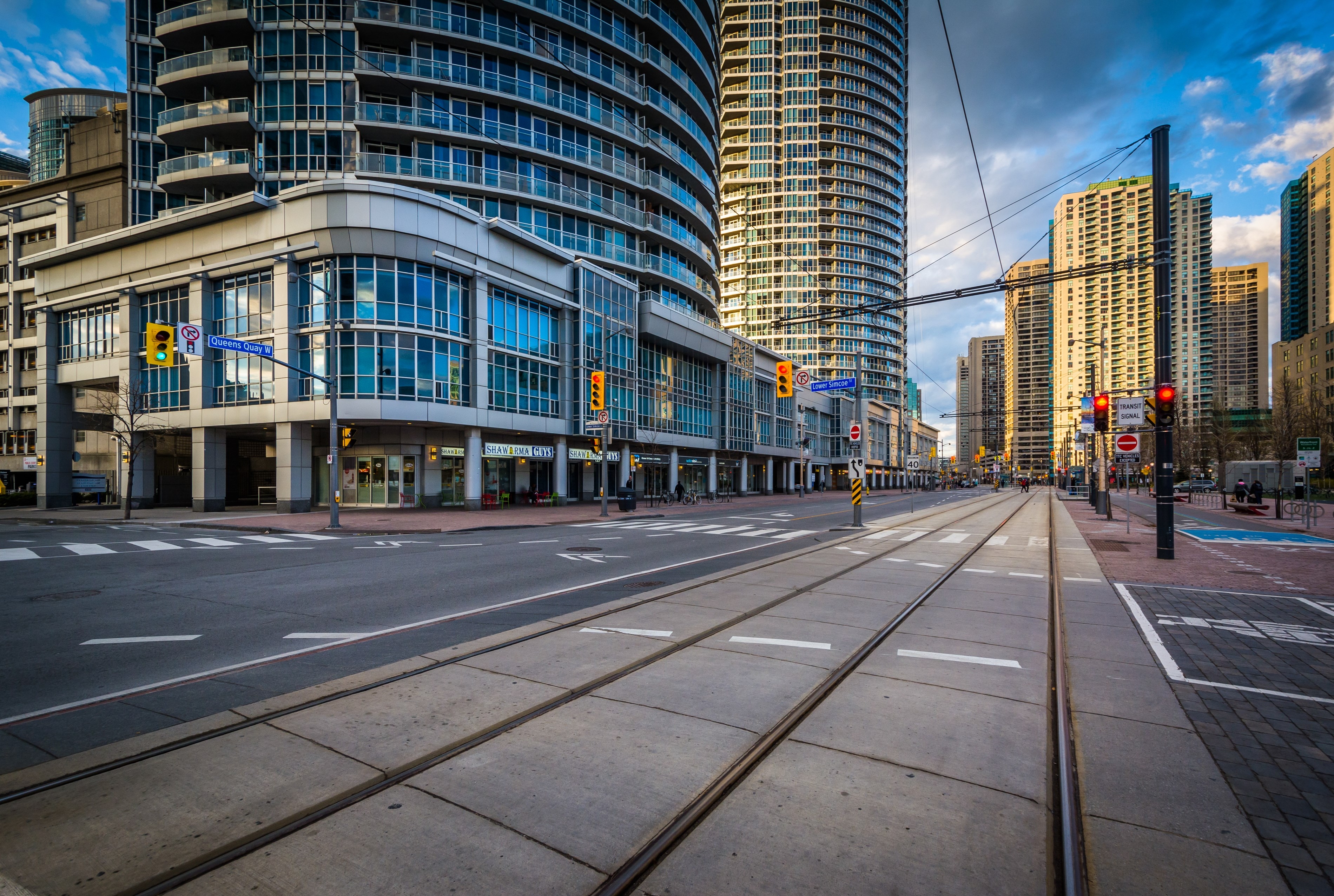 Streetcar tracks and modern buildings along Queens Quay West, at the Harbourfront, in Toronto, Ontario.