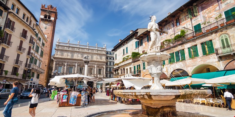Sunny view of the Piazza delle Erbe, palazzo Maffei and Gardello tower at historical center of Verona, Veneto region, Italy.