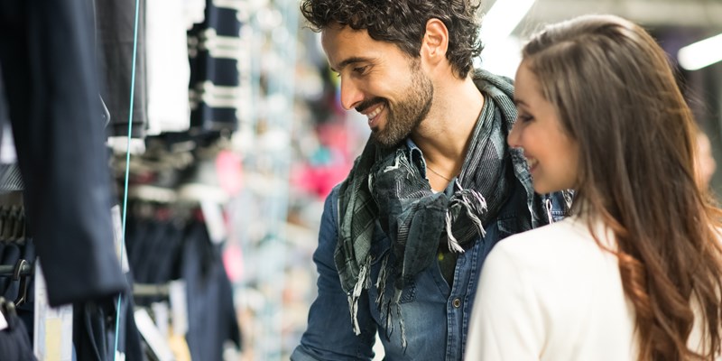 Happy couple shopping in a dress shop