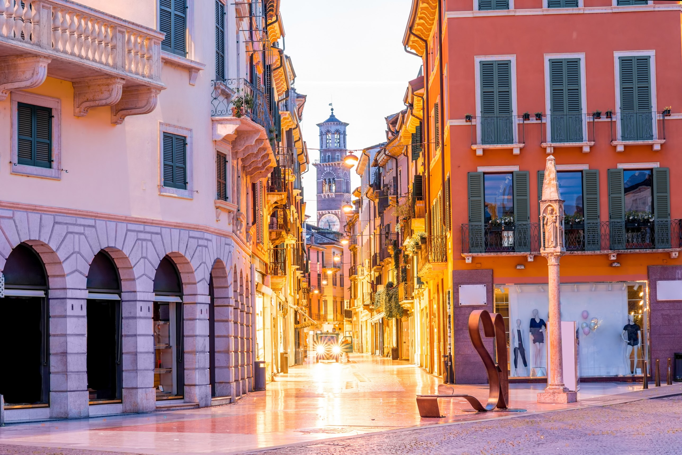 Night view on Giuseppe Mazzini famous commercial street with Lamberty tower in Verona city.