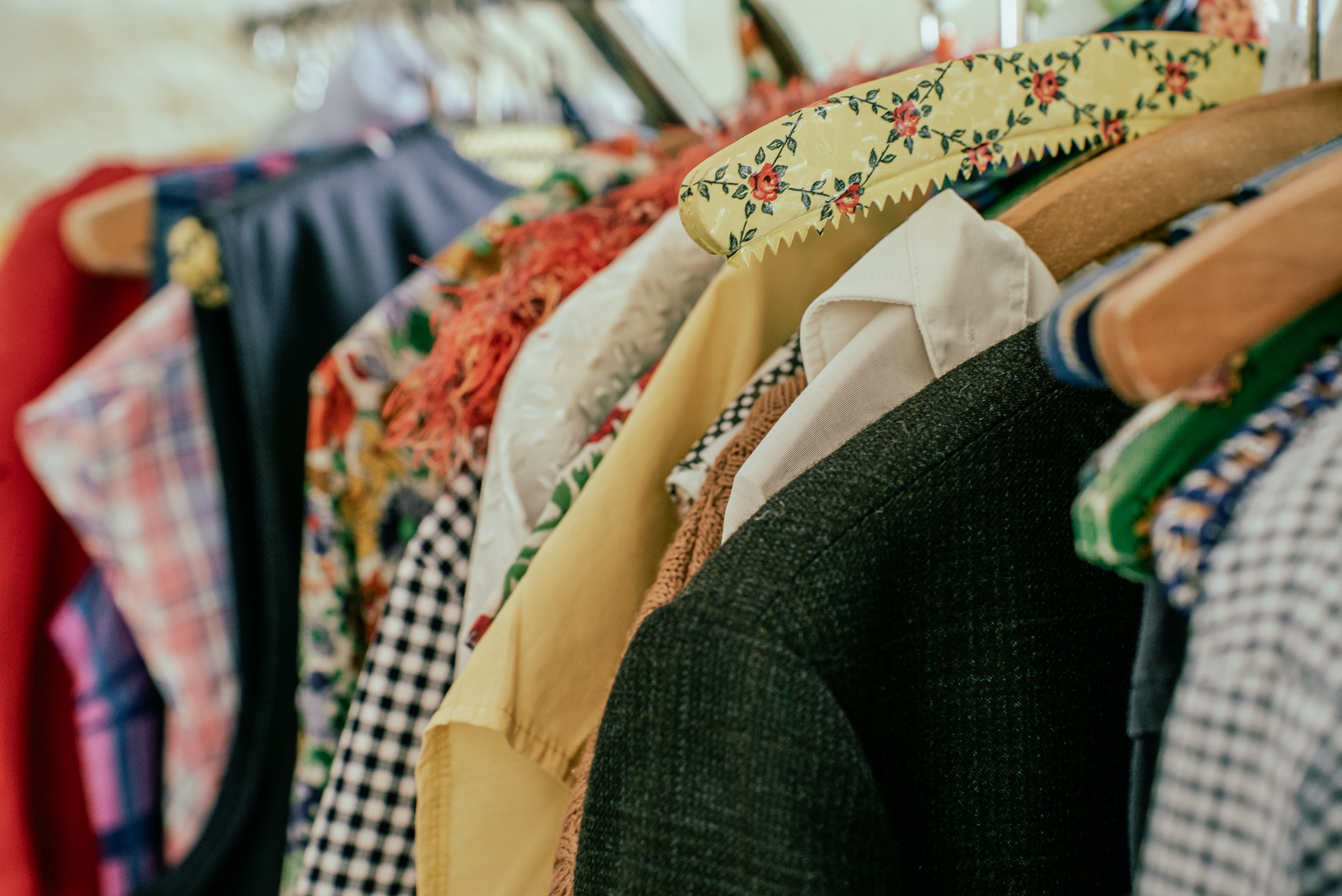 Vintage clothes hanging on hangers at a fair
