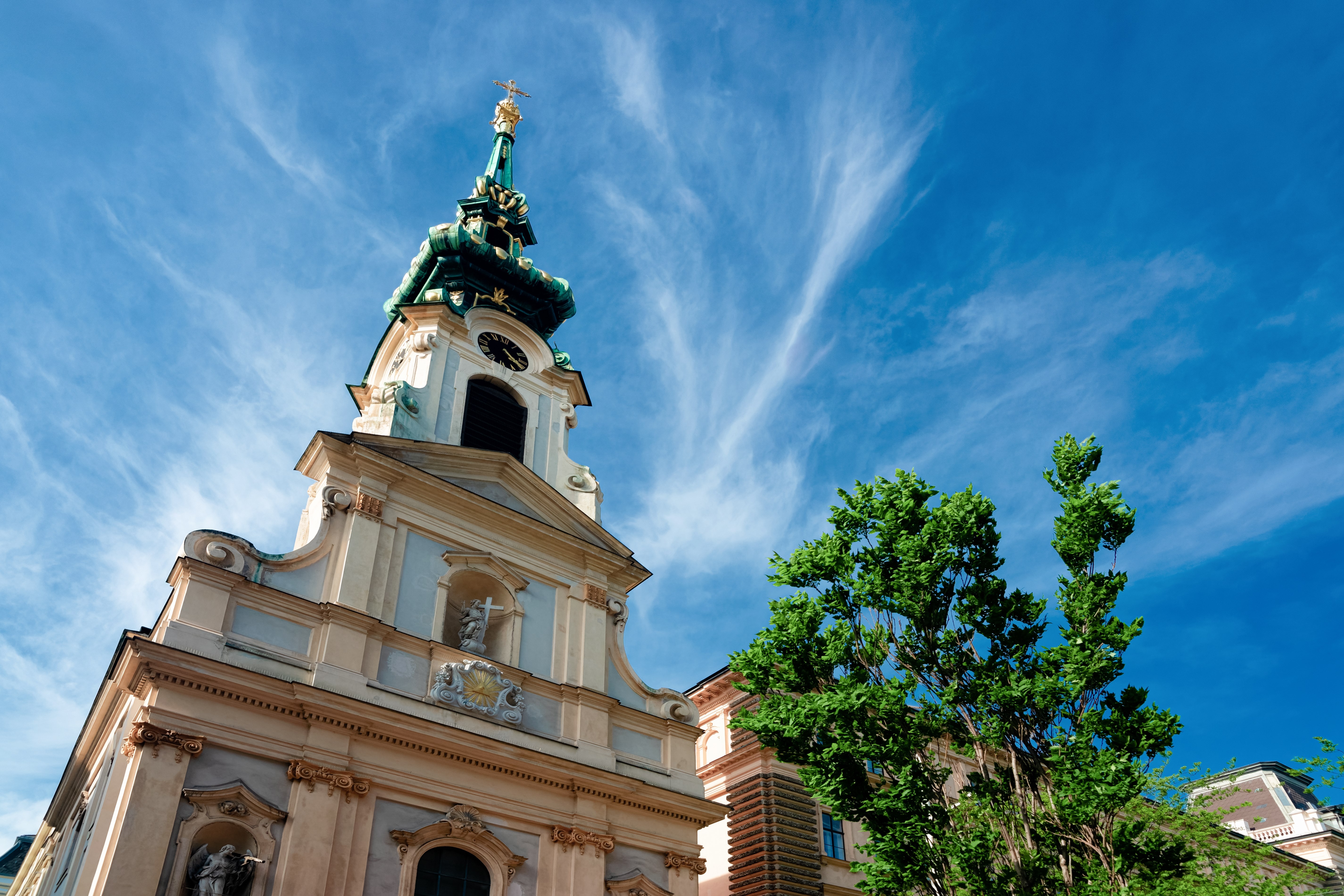 Tower of Stiftskirche Church on Mariahilfer Strasse Street in Vienna