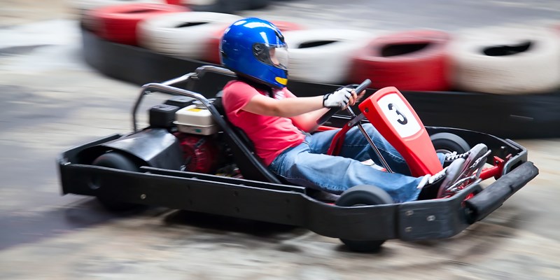 Indoor karting race (rushing kart and safety barriers)