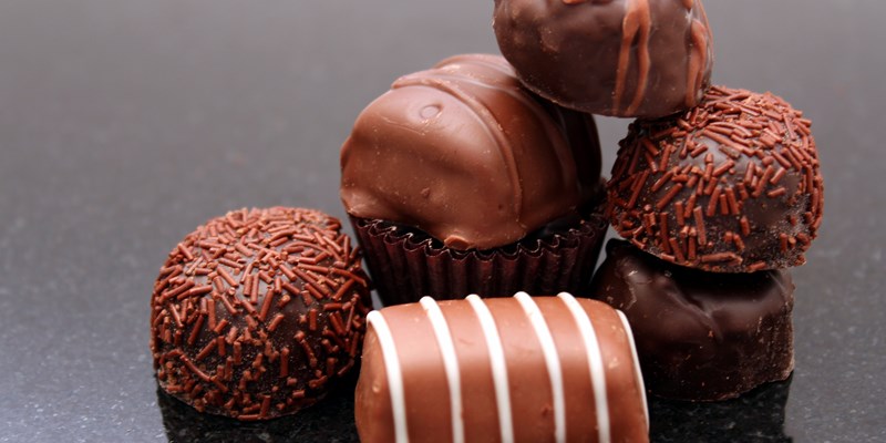CHOCOLATE TRUFFLES UP CLOSE ON MARBLE COUNTER