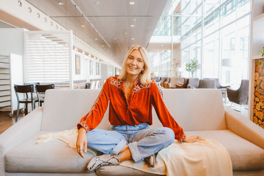 Josefin Dahlberg sitter på en vit soffa Josefin Dahlberg sitter på en vit soffa