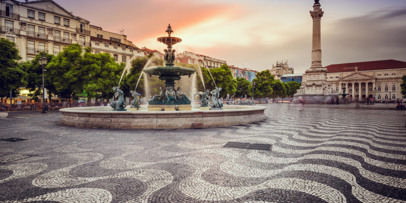 Torg och fontän i Lissabon i skymning Torg och fontän i Lissabon i skymning